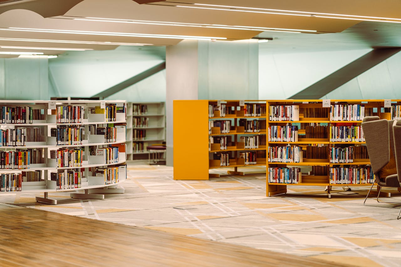 cta-02 Spacious and well-lit library interior with modern bookshelves in Dubai's academic hub.